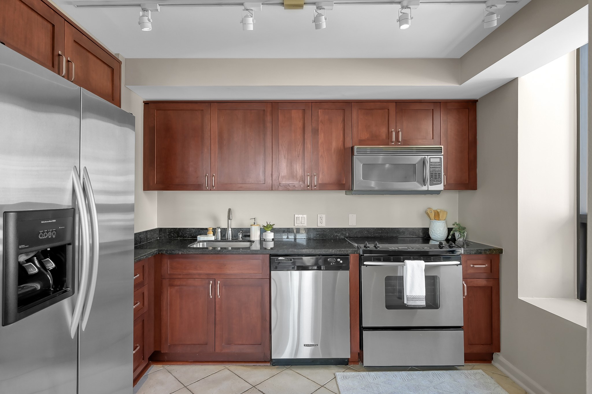 1111 Caroline Street, Unit 2901 Houston, TX 77010 - Photo 14 of 46 a kitchen with stainless steel appliances granite countertop a stove a sink and a microwave