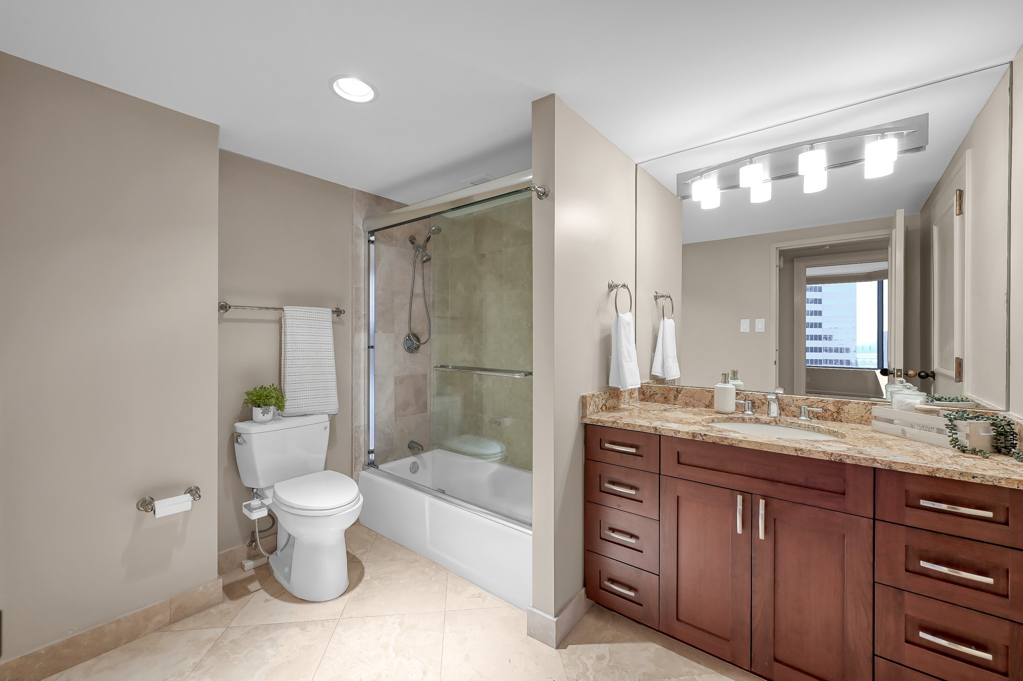 1111 Caroline Street, Unit 2901 Houston, TX 77010 - Photo 21 of 46 a spacious bathroom with a granite countertop sink toilet and shower