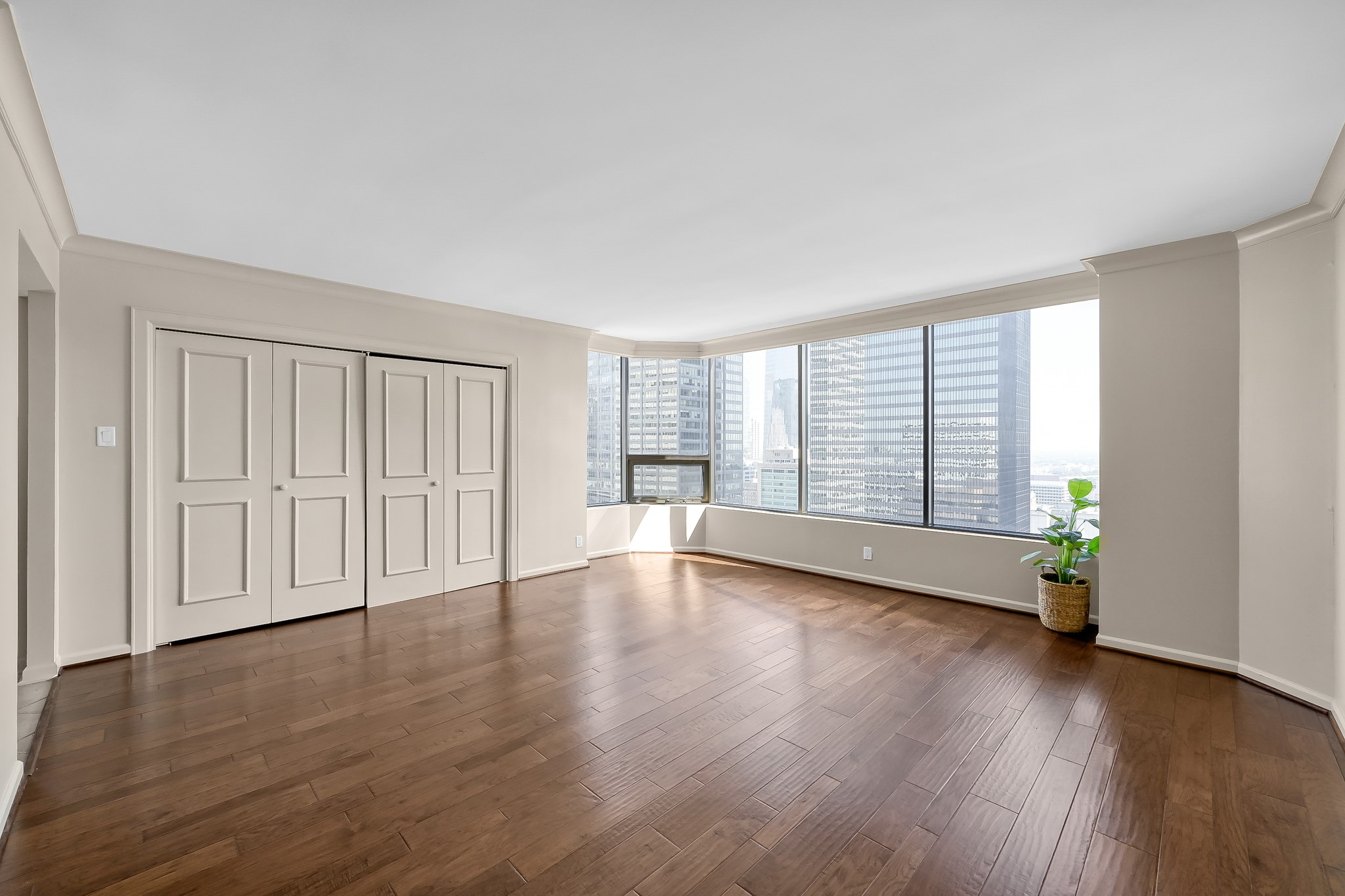 1111 Caroline Street, Unit 2901 Houston, TX 77010 - Photo 10 of 46 a view of an empty room with wooden floor and a window