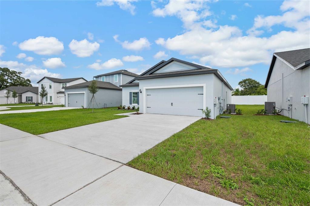 13261 Tula Loop Astatula, FL 34705 - Photo 2 of 25 a view of a front of house with a yard