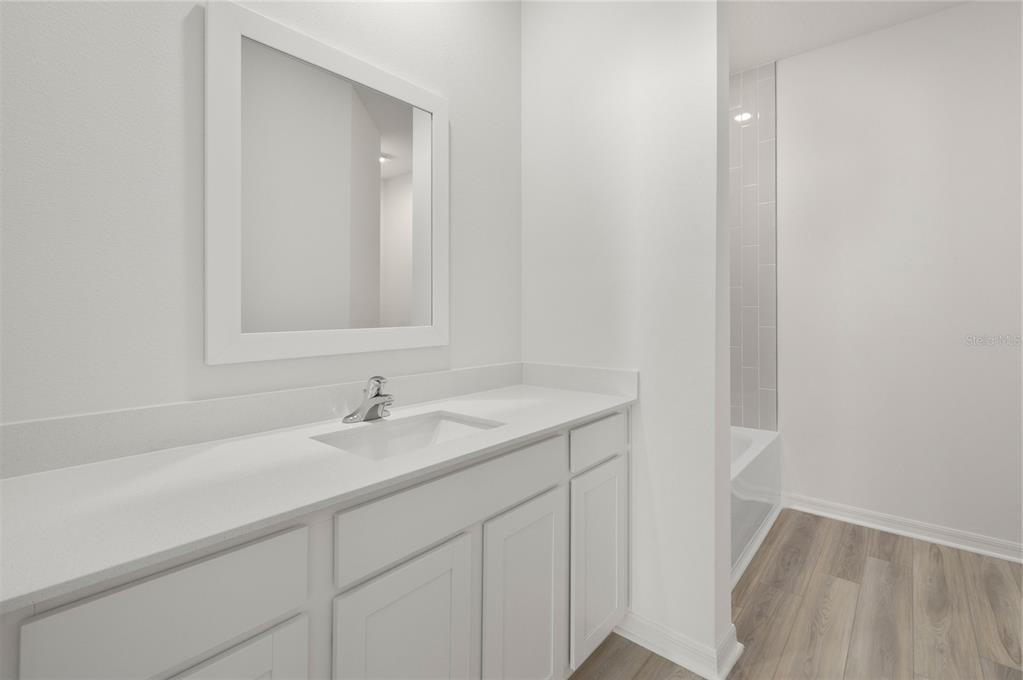 13261 Tula Loop Astatula, FL 34705 - Photo 22 of 25 a bathroom with a sink and a mirror