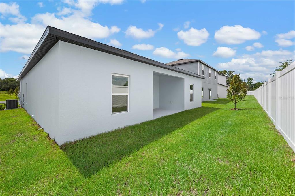 13261 Tula Loop Astatula, FL 34705 - Photo 24 of 25 a view of an house with backyard space and garden