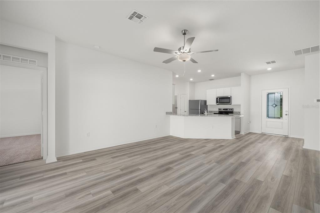 13261 Tula Loop Astatula, FL 34705 - Photo 9 of 25 a view of kitchen with cabinets and wooden floor