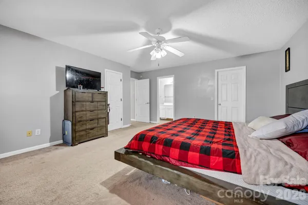 a bedroom with a bed and a ceiling fan