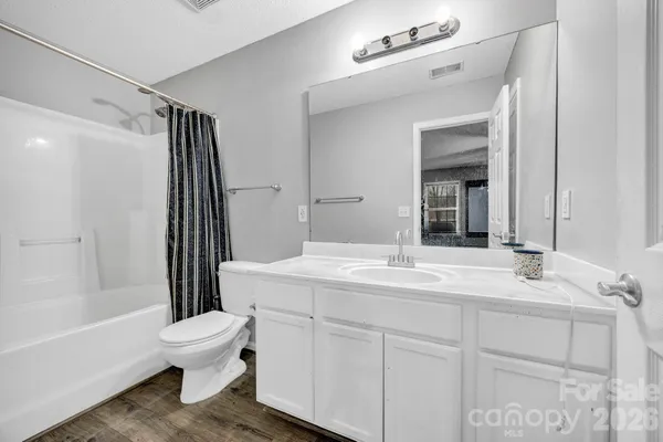 a bathroom with a sink toilet vanity and tub