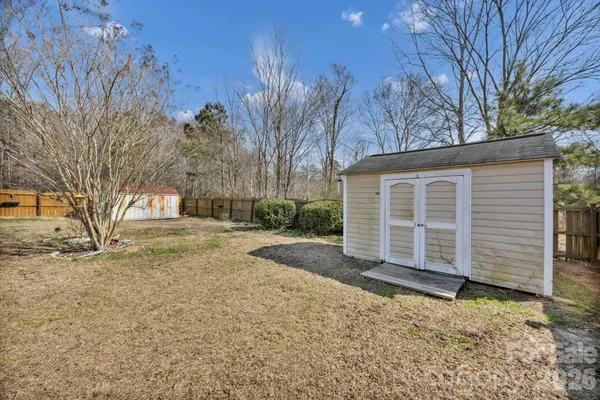 a view of a house with a yard covered with snow