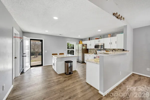 a kitchen with refrigerator and cabinets