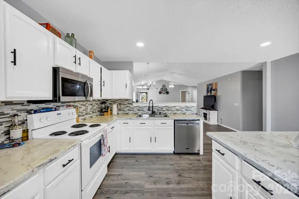 a kitchen with a sink stove and microwave