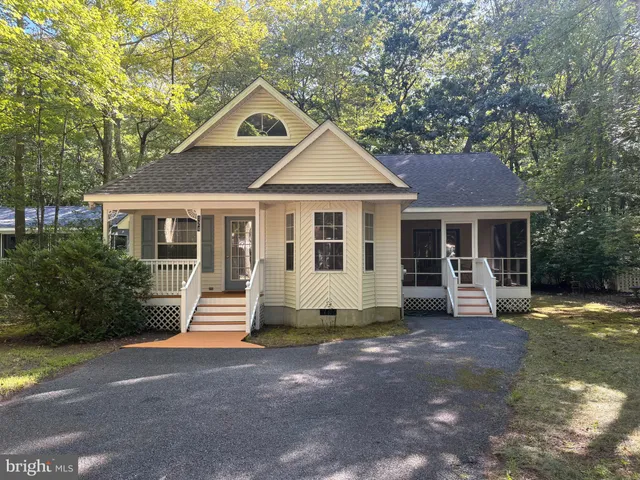 a front view of a house with a garden and porch
