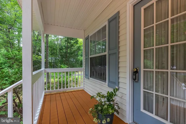a view of a balcony with floor to ceiling windows and wooden floor