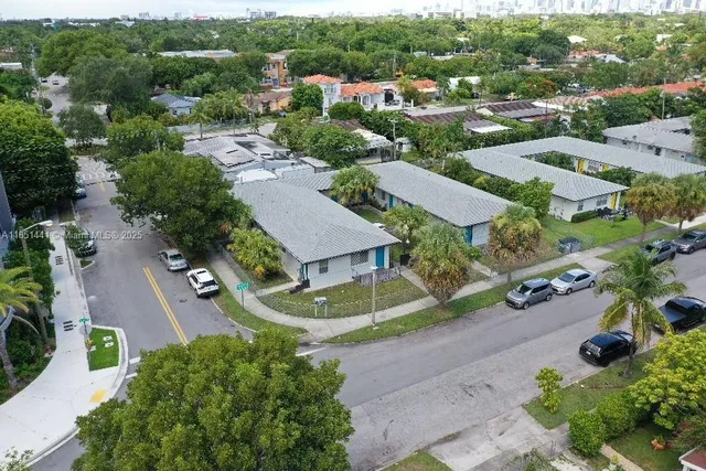 an aerial view of residential houses with outdoor space and street view