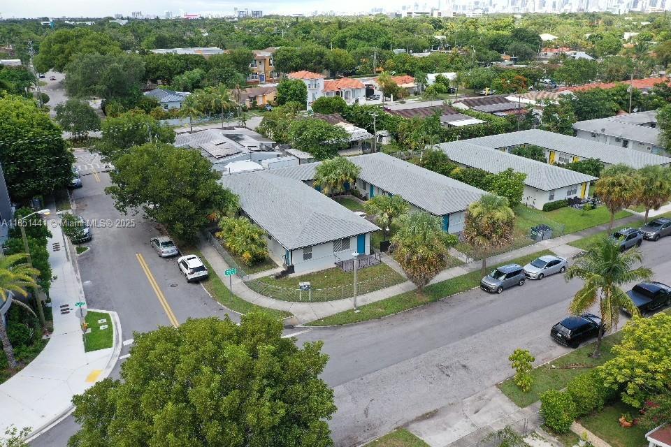 an aerial view of residential houses with outdoor space and street view