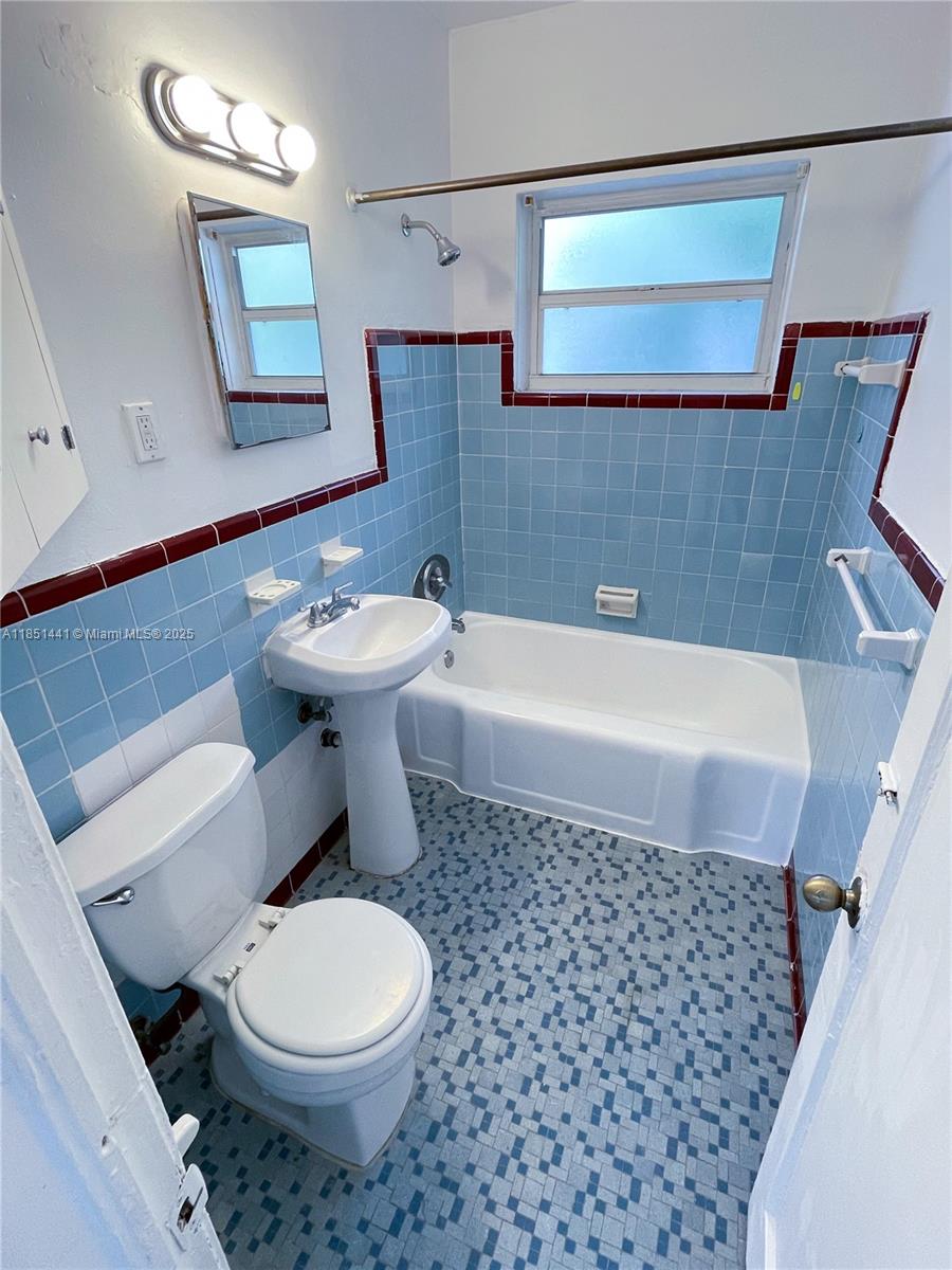 2499 Southwest 27th Street, Unit 9 Miami, FL 33133 - Photo 11 of 19 a bathroom with a sink toilet and mirror