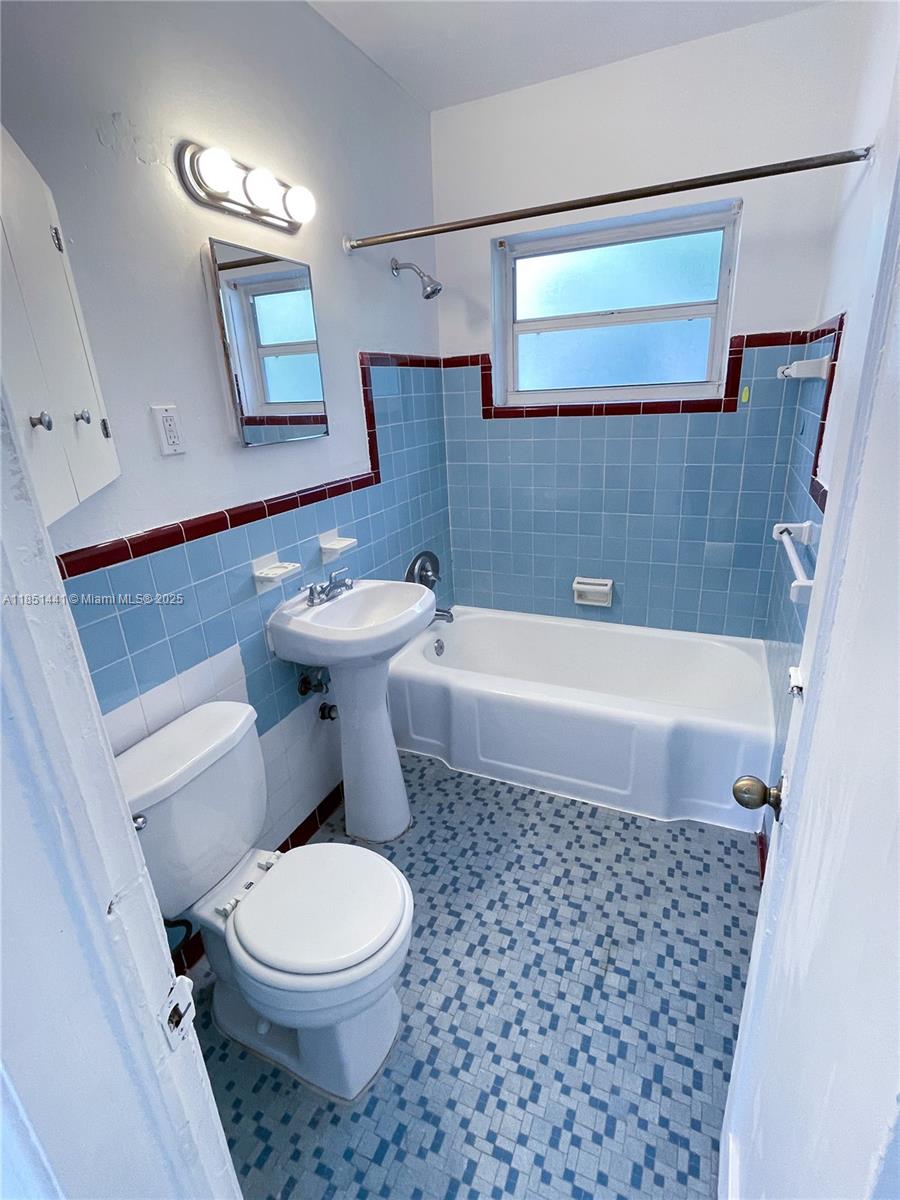 2499 Southwest 27th Street, Unit 9 Miami, FL 33133 - Photo 12 of 19 a bathroom with a toilet a sink and bathtub