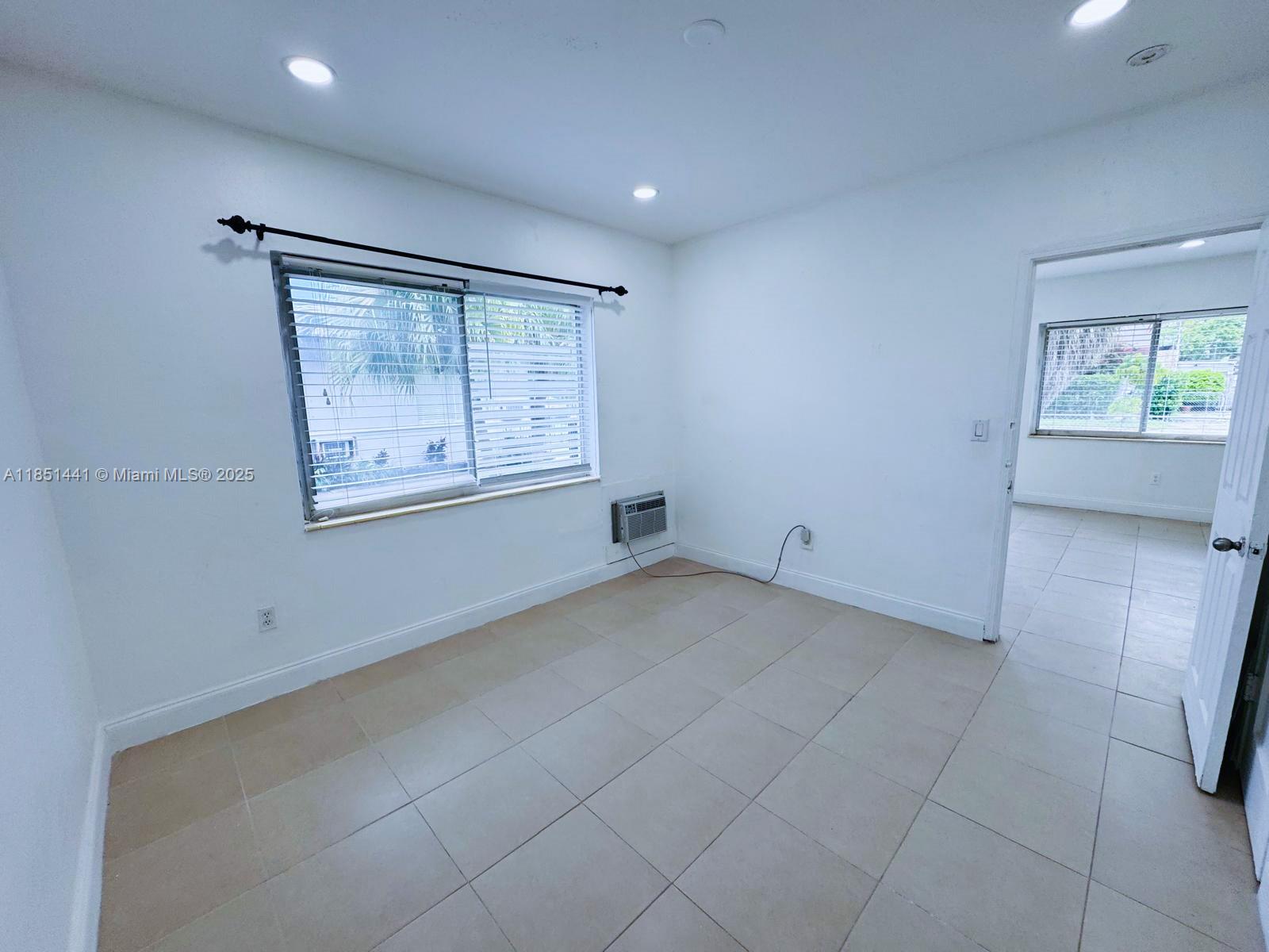 2499 Southwest 27th Street, Unit 9 Miami, FL 33133 - Photo 15 of 19 a view of an empty room with a window