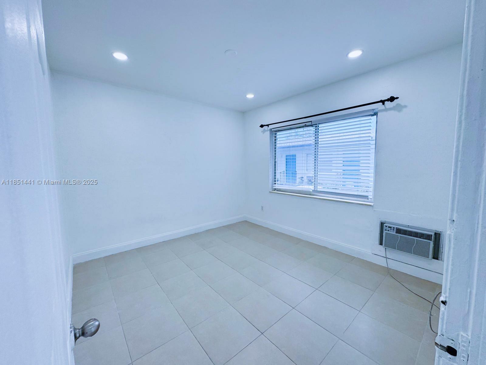 2499 Southwest 27th Street, Unit 9 Miami, FL 33133 - Photo 16 of 19 a view of an empty room with a window