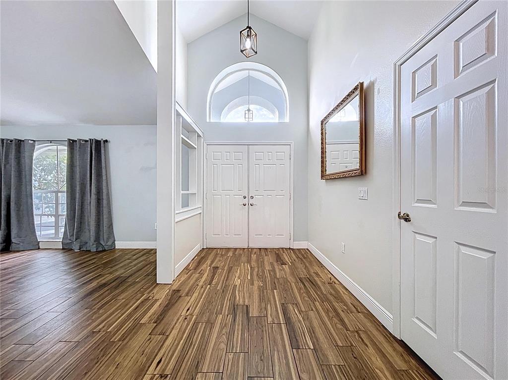 18812 Bascomb Lane Hudson, FL 34667 - Photo 14 of 57 a view of a livingroom with wooden floor and a window