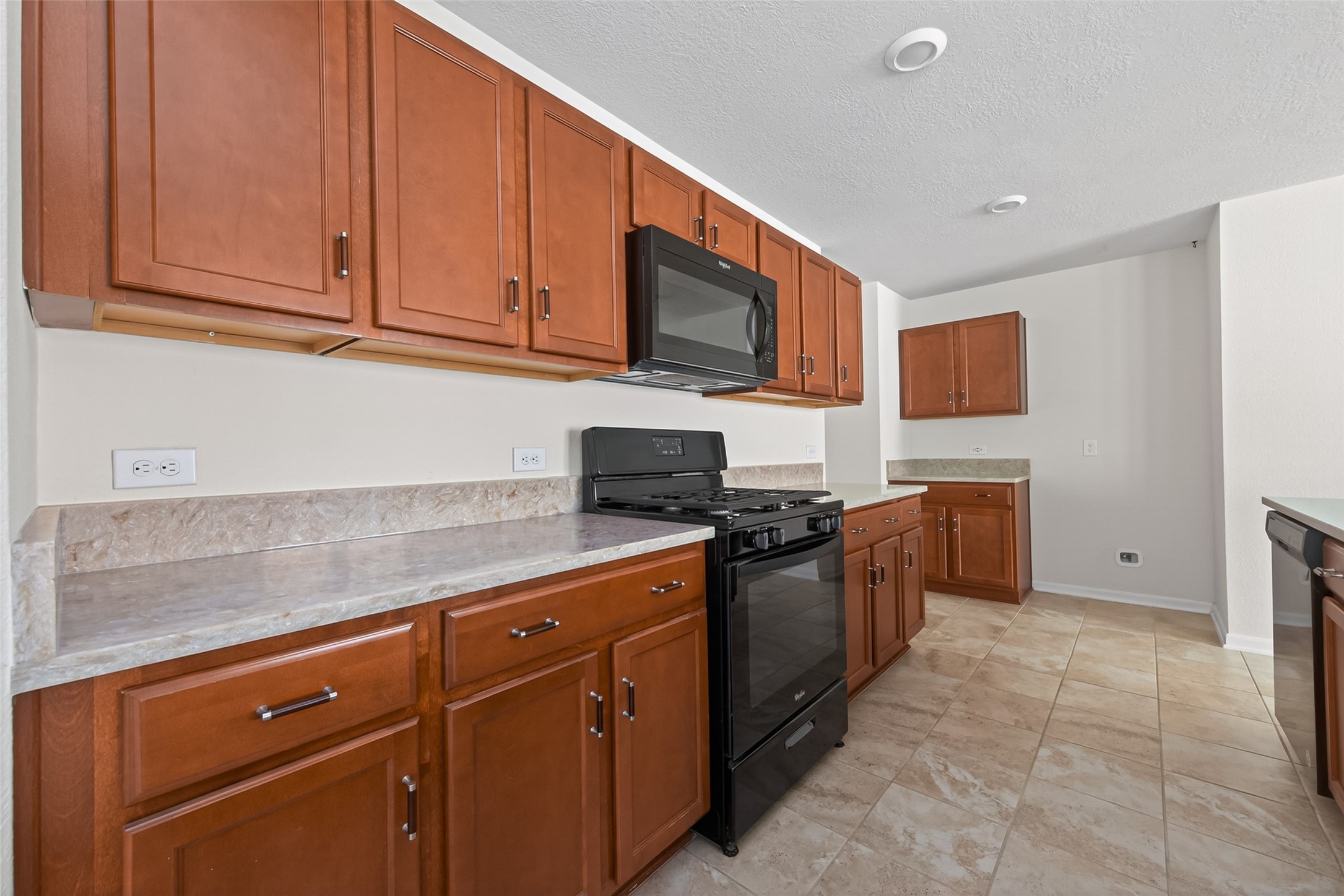 2754 Cayden Creek Way Conroe, TX 77304 - Photo 13 of 40 a kitchen with stainless steel appliances granite countertop a stove a sink and a refrigerator