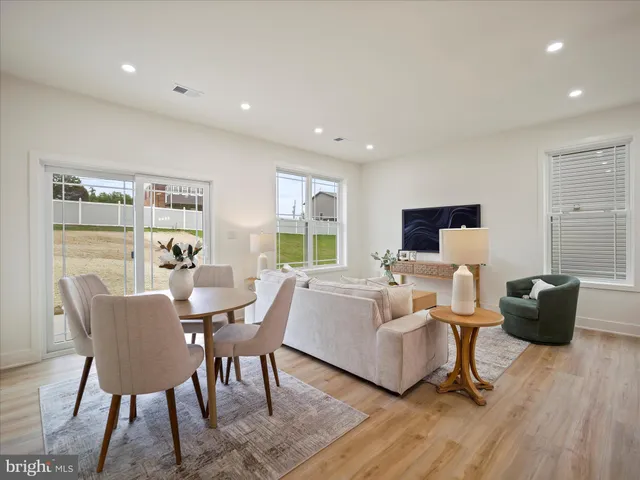 a view of a dining room with furniture window and wooden floor