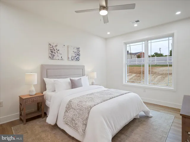 a bedroom with a bed and a potted plant