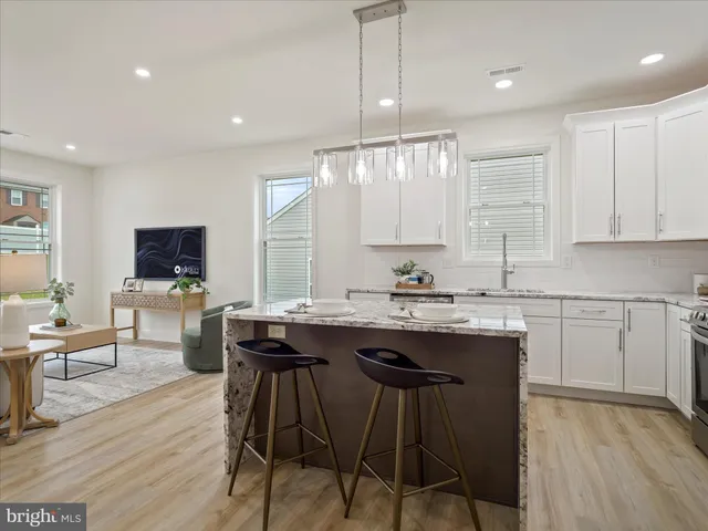 a kitchen with a sink cabinets and wooden floor