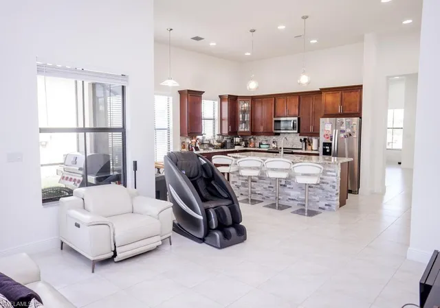 a view of a living room kitchen and a large window