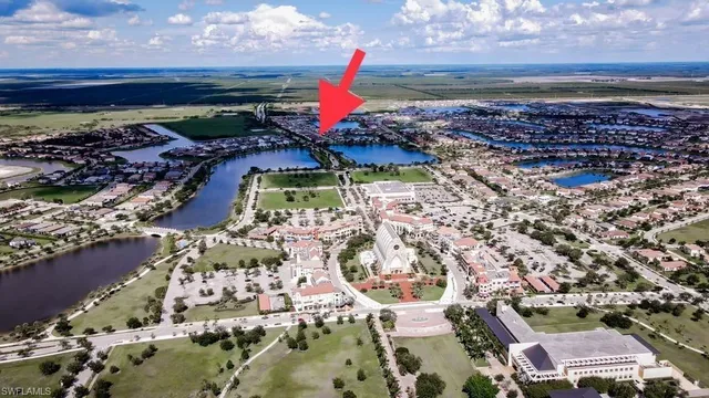 with aerial view of a house with a yard and lake view