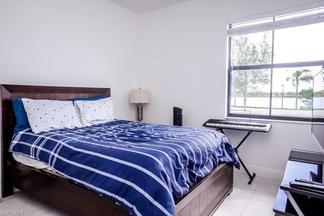 a bedroom with a bed and window