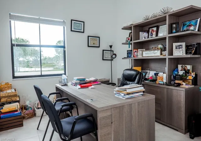 a view of a dining room with furniture and a window