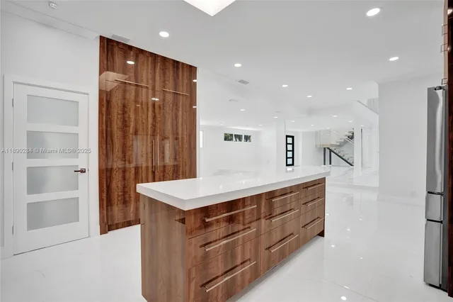 a kitchen with a cabinets and a refrigerator