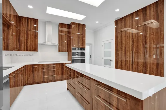 a kitchen with stainless steel appliances a sink and a refrigerator