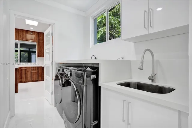 a kitchen with a sink a washer and dryer