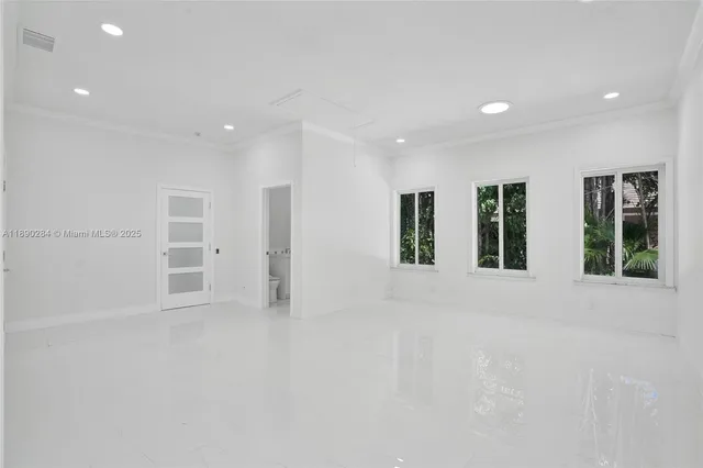 a view of an empty room with windows