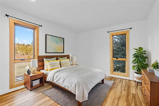 a bed sitting in a bedroom next to a window