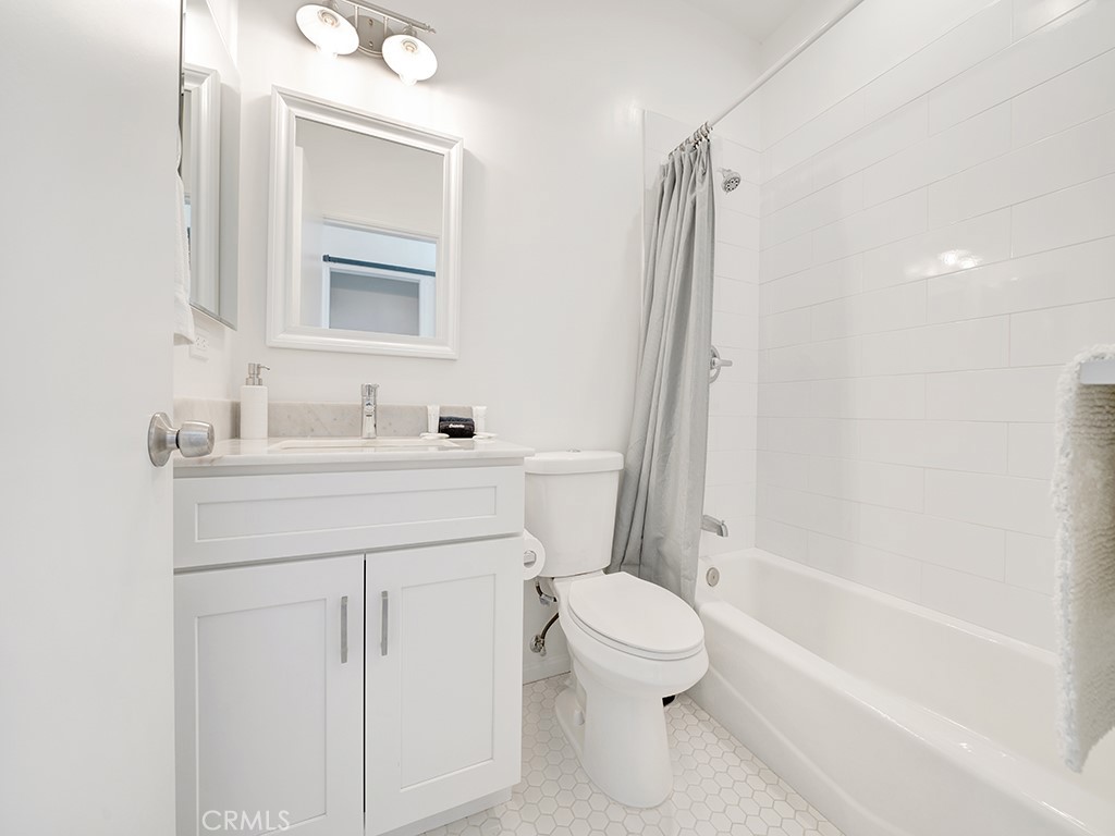 129 45th Street Newport Beach, CA 92663 - Photo 26 of 38 a bathroom with a sink toilet vanity and shower