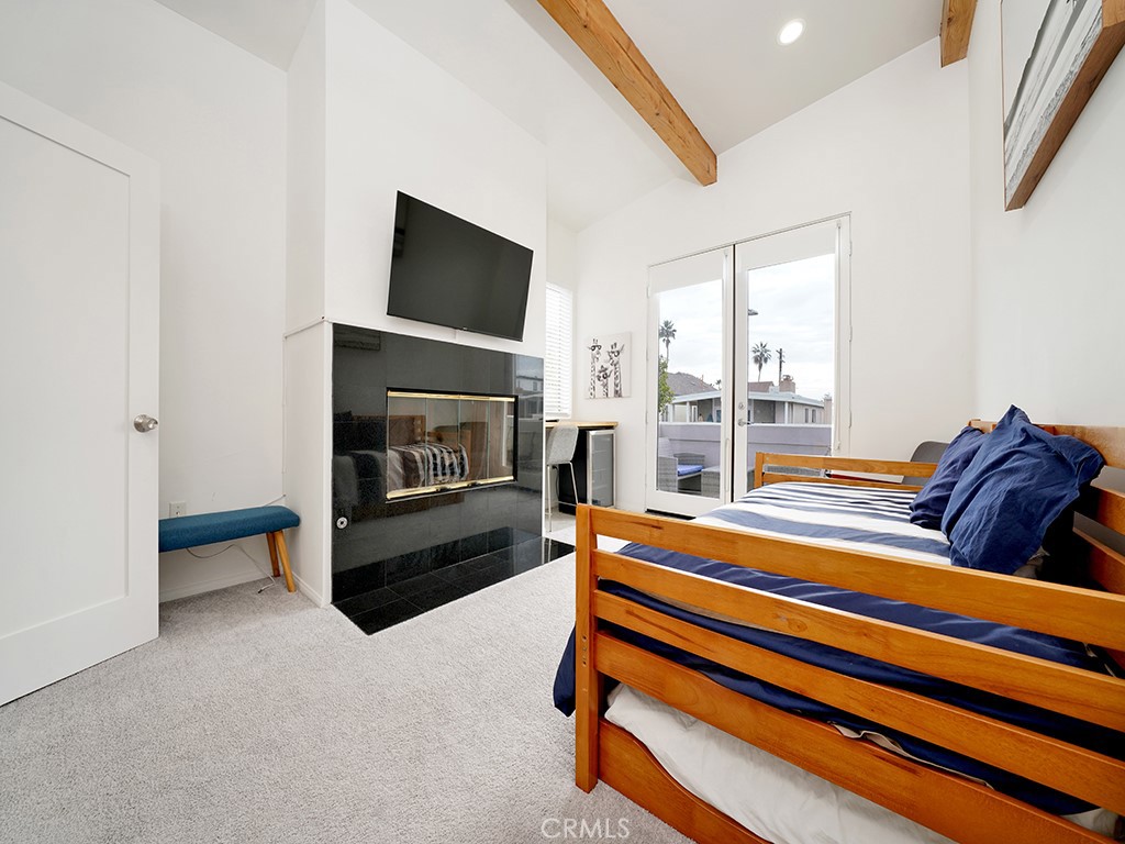 129 45th Street Newport Beach, CA 92663 - Photo 29 of 38 a bedroom with furniture and a fireplace