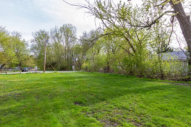 a view of a lake with table and chairs