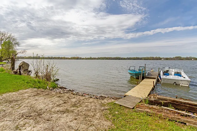 a view of a lake with houses in the back