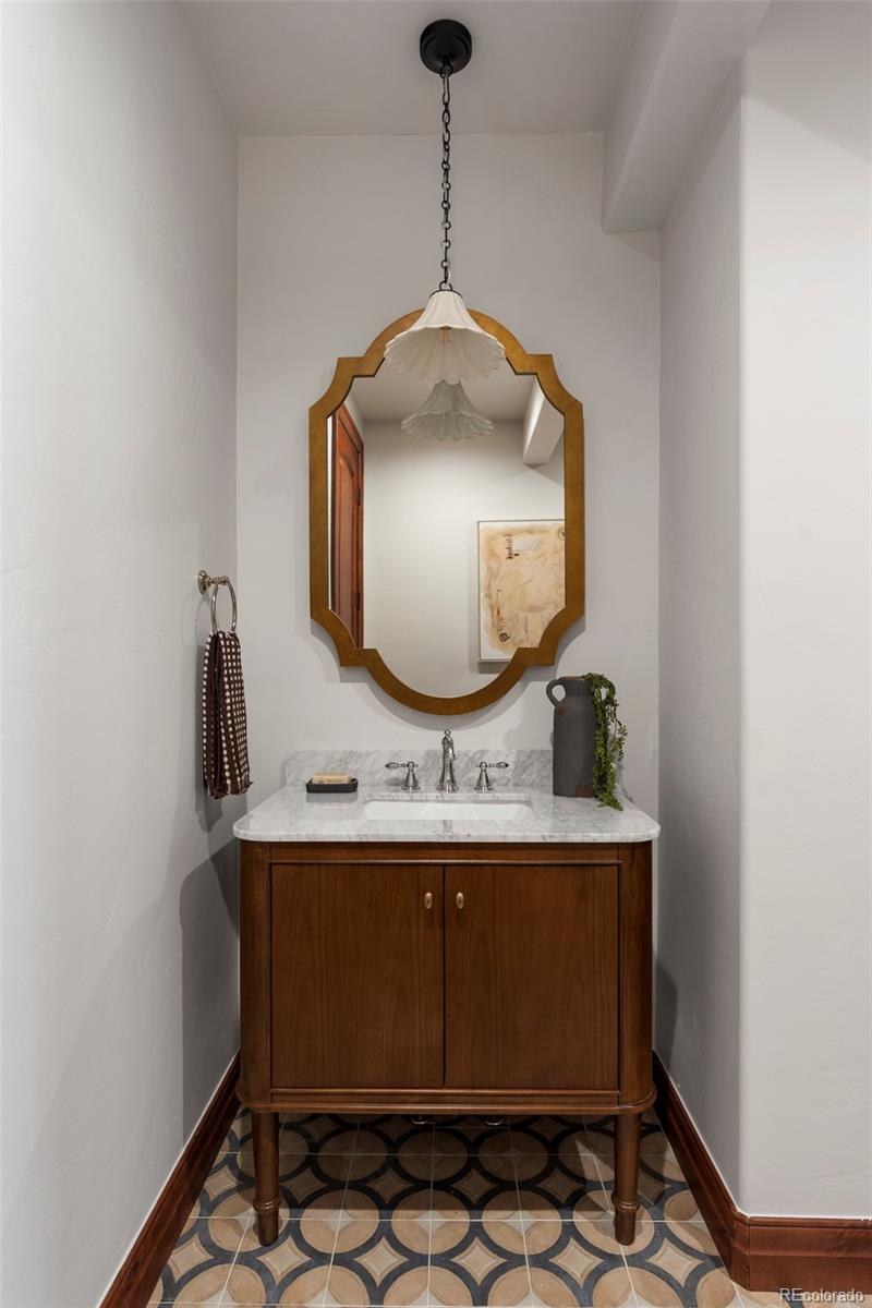 1026 South Cook Street Denver, CO 80209 - Photo 15 of 34 a bathroom with a sink and a mirror