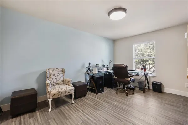 a view of a workspace with furniture and a window