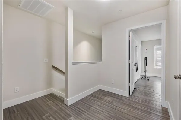 a view of a hallway with wooden floor