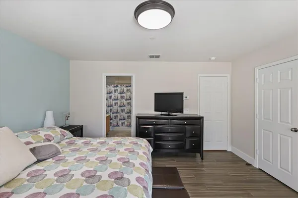 a bedroom with a bed and a flat screen tv