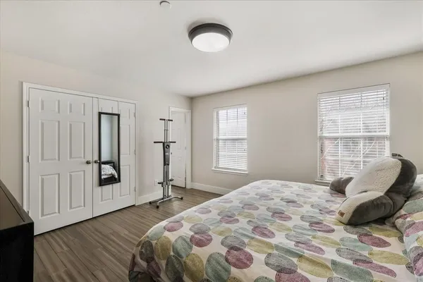 a bedroom with a bed and wooden floor