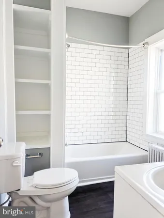 a bathroom with a sink a toilet and a bathtub