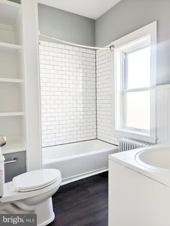 a bathroom with a bathtub and a toilet