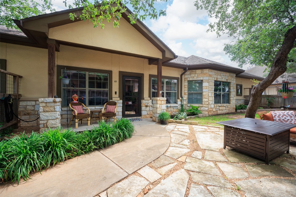 Welcome home as you enter into a lush gardeners courtyard filled with well-tended flowerbeds, hanging vines, shady oak trees and two lovely patio seating areas.