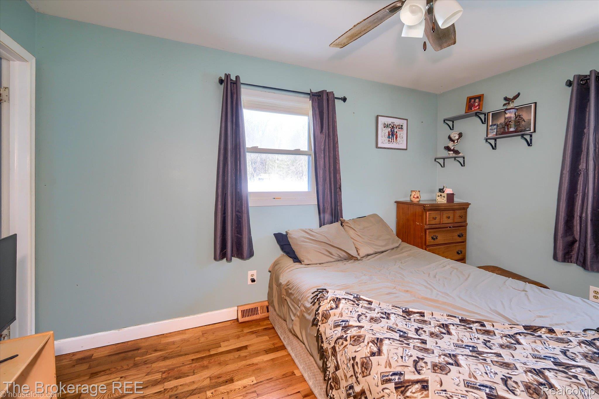 5477 Hopkins Road Flint, MI 48506 - Photo 13 of 27 Bedroom with light wood-style flooring and ceiling fan
