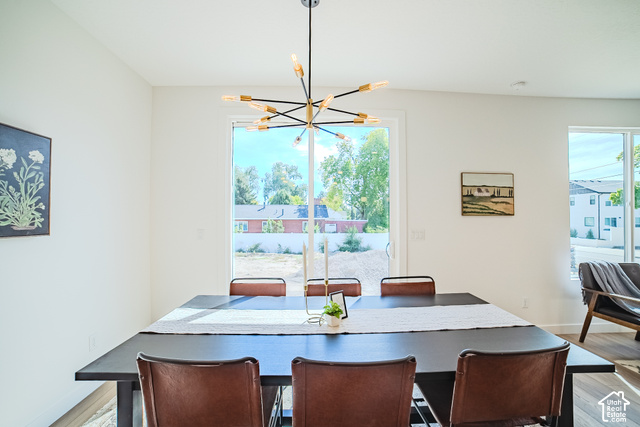 342 Perrine Drive Midvale, UT 84047 - Photo 6 of 37 Expansive glass sliding door, large picture window, and wood-finish flooring