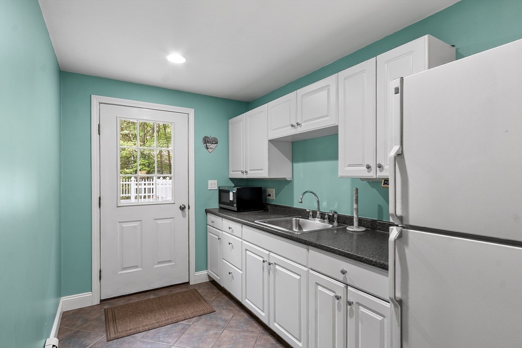 622 Townsend Road Groton, MA 01450 - Photo 29 of 39 a kitchen with granite countertop a sink stainless steel appliances and cabinets
