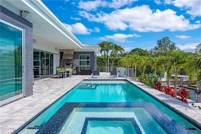 a view of swimming pool with outdoor seating and a patio